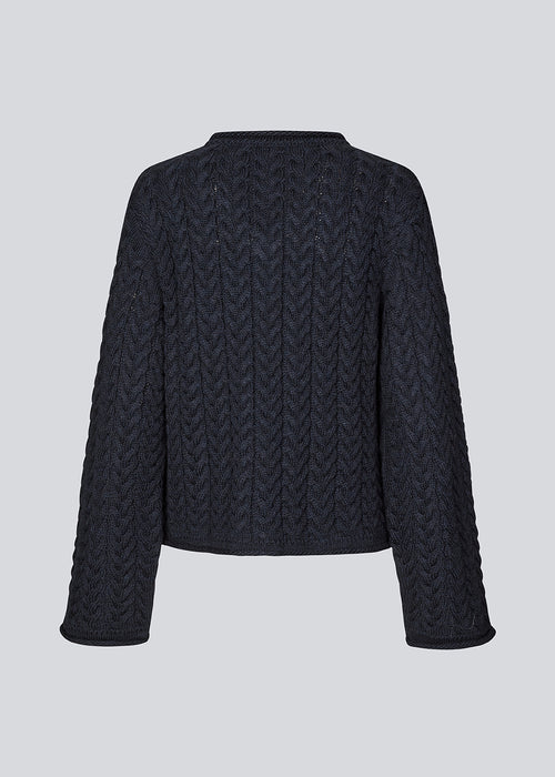 Loose wool knit in navy blue with wide sleeves. KurtisMD v-neck has a v-neck and rolled edges.