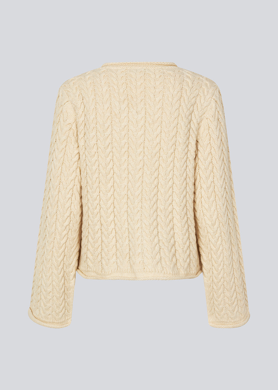 Loose wool knit in creme color with wide sleeves. KurtisMD v-neck has a v-neck and rolled edges.