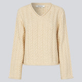 Loose wool knit in creme color with wide sleeves. KurtisMD v-neck has a v-neck and rolled edges.