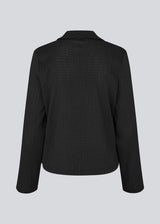Classic shirt with tieband closure in an elastic and slightly see-through material. LaceyMD shirt has wide sleeves with slits and tree tiebands in front.