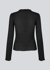 Longsleeved black top in an elastic and slighly see-through material. LaceyMD is fitted and has a high neck.