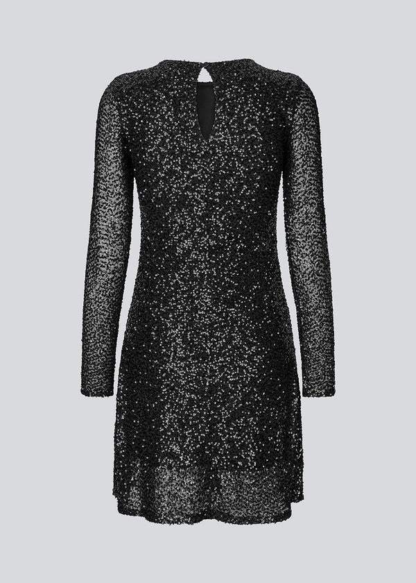 Black short dress with sequins. LaraMD dress has a slim silhouette with a round neck and longsleeves, along with a keyhole opening at the back with a button closure.
