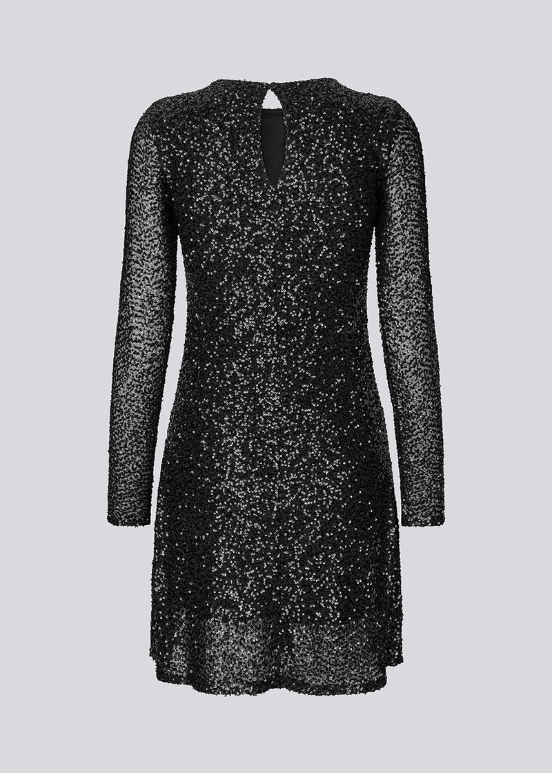 Black short dress with sequins. LaraMD dress has a slim silhouette with a round neck and longsleeves, along with a keyhole opening at the back with a button closure.
