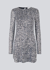 Short dress with silver sequins. LaraMD dress has a slim silhouette with a round neck and longsleeves, along with a keyhole opening at the back with a button closure.