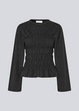 Longsleeved black t-shirt in jersey with a smock detail. LillieMD LS top has long wide sleeves and a round neck.