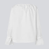 Loose white top with lang sleeves with tiebands. LylaMD top has a round neck with a tieband.