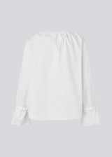Loose white top with lang sleeves with tiebands. LylaMD top has a round neck with a tieband.