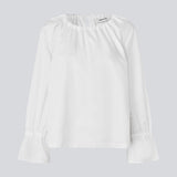 Loose white top with lang sleeves with tiebands. LylaMD top has a round neck with a tieband.