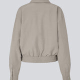 Short jacket with elasic in the buttom. MaggieMD jacket has a collar, zipper closure and sidepockets.