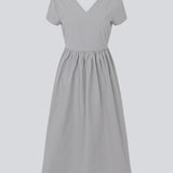 Long dress with short sleeves and a bow detail. MalleMD long dress is fitted with a loose skirt and has an invisible zipper in the side.