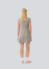 Short fitted dress with pleats. MarlyMD dress has a v-neck and an invisible zipper in the back.