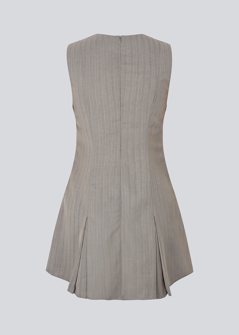 Short fitted dress with pleats. MarlyMD dress has a v-neck and an invisible zipper in the back.