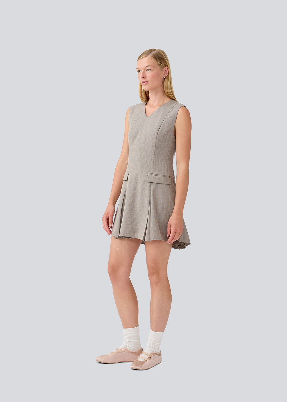 Short fitted dress with pleats. MarlyMD dress has a v-neck and an invisible zipper in the back.