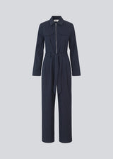 Long jumpsuit with a belt and shirtcollar. MathildeMD jumpsuit has long sleeves, a zipper in front and side pockets.