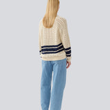 Loose knitted cardigan in beige with navy blue stripes in the button in cable knit. MetteMD cardigan is slightly see-through and has loose sleeves and a button closure. The models are 177 cm and wear a size S/36.&nbsp;
