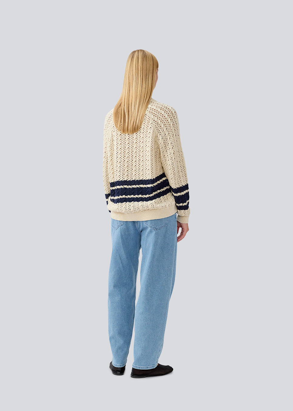 Loose knitted cardigan in beige with navy blue stripes in the button in cable knit. MetteMD cardigan is slightly see-through and has loose sleeves and a button closure. The models are 177 cm and wear a size S/36.&nbsp;
