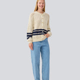 Loose knitted cardigan in beige with navy blue stripes in the button in cable knit. MetteMD cardigan is slightly see-through and has loose sleeves and a button closure. The models are 177 cm and wear a size S/36.&nbsp;
