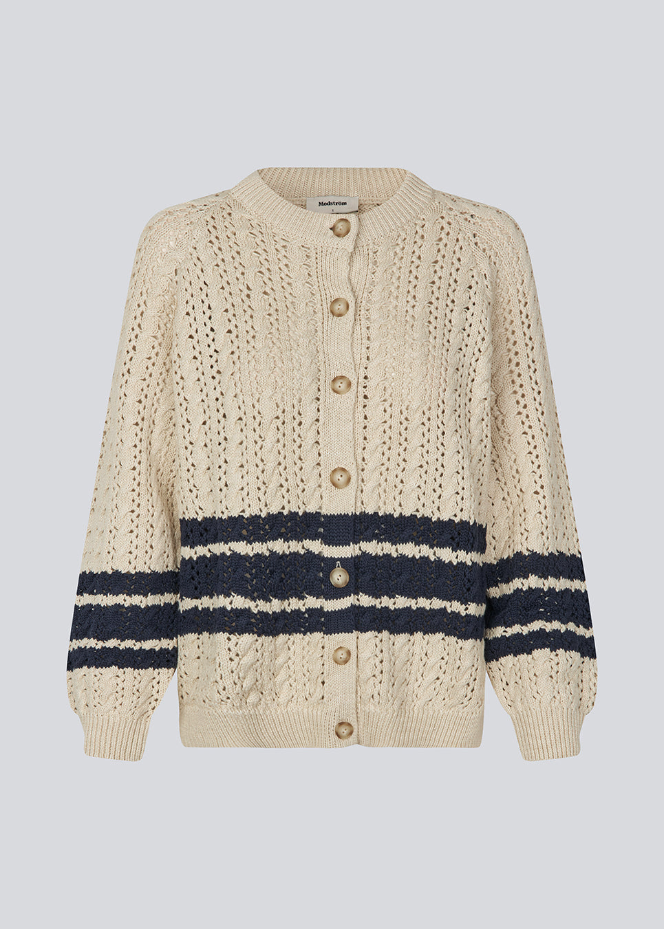 Loose knitted cardigan in beige with navy blue stripes in the button in cable knit. MetteMD cardigan is slightly see-through and has loose sleeves and a button closure. The models are 177 cm and wear a size S/36.&nbsp;
