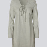 Short fitted dress with a v-neck with a lace-up detail. MickyMD dress has long sleeves and a zipper in the side.