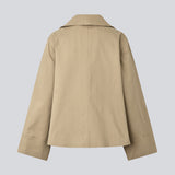 Beige jacket with an asymetrical closure. MillaMD jacket has two pockets in front, collar and wide sleeves. 