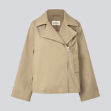Beige jacket with an asymetrical closure. MillaMD jacket has two pockets in front, collar and wide sleeves. 