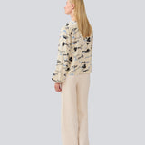 Shirt with V-neck and loose sleeves. MistMD print top has a loose fit and a button closure with fabric covered buttons.