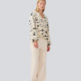 Shirt with V-neck and loose sleeves. MistMD print top has a loose fit and a button closure with fabric covered buttons.