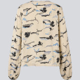 Shirt with V-neck and loose sleeves. MistMD print top has a loose fit and a button closure with fabric covered buttons.