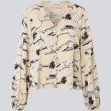 Shirt with V-neck and loose sleeves. MistMD print top has a loose fit and a button closure with fabric covered buttons.