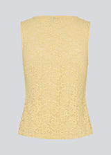 Sleeveless lace top in yellow with a v-neck. MamumdMD top is fitted and has a button closure in front.