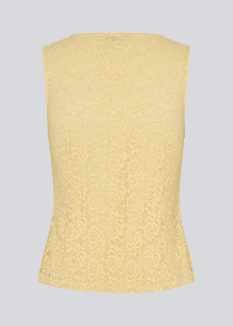 Sleeveless lace top in yellow with a v-neck. MamumdMD top is fitted and has a button closure in front.