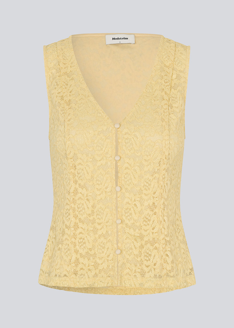 Sleeveless lace top in yellow with a v-neck. MamumdMD top is fitted and has a button closure in front.