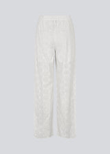 White pants with wide legs in broderie anglaise. NanetteMD pants have an elastic waistband and lining.