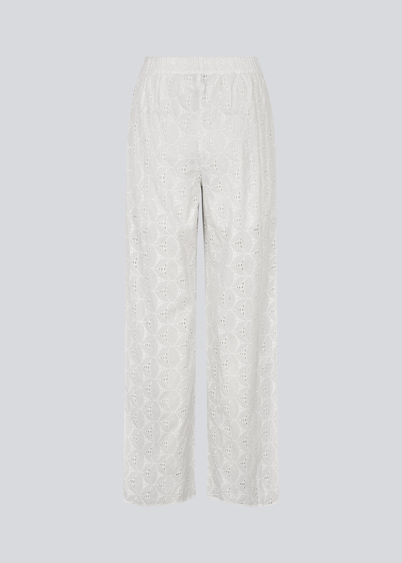 White pants with wide legs in broderie anglaise. NanetteMD pants have an elastic waistband and lining.