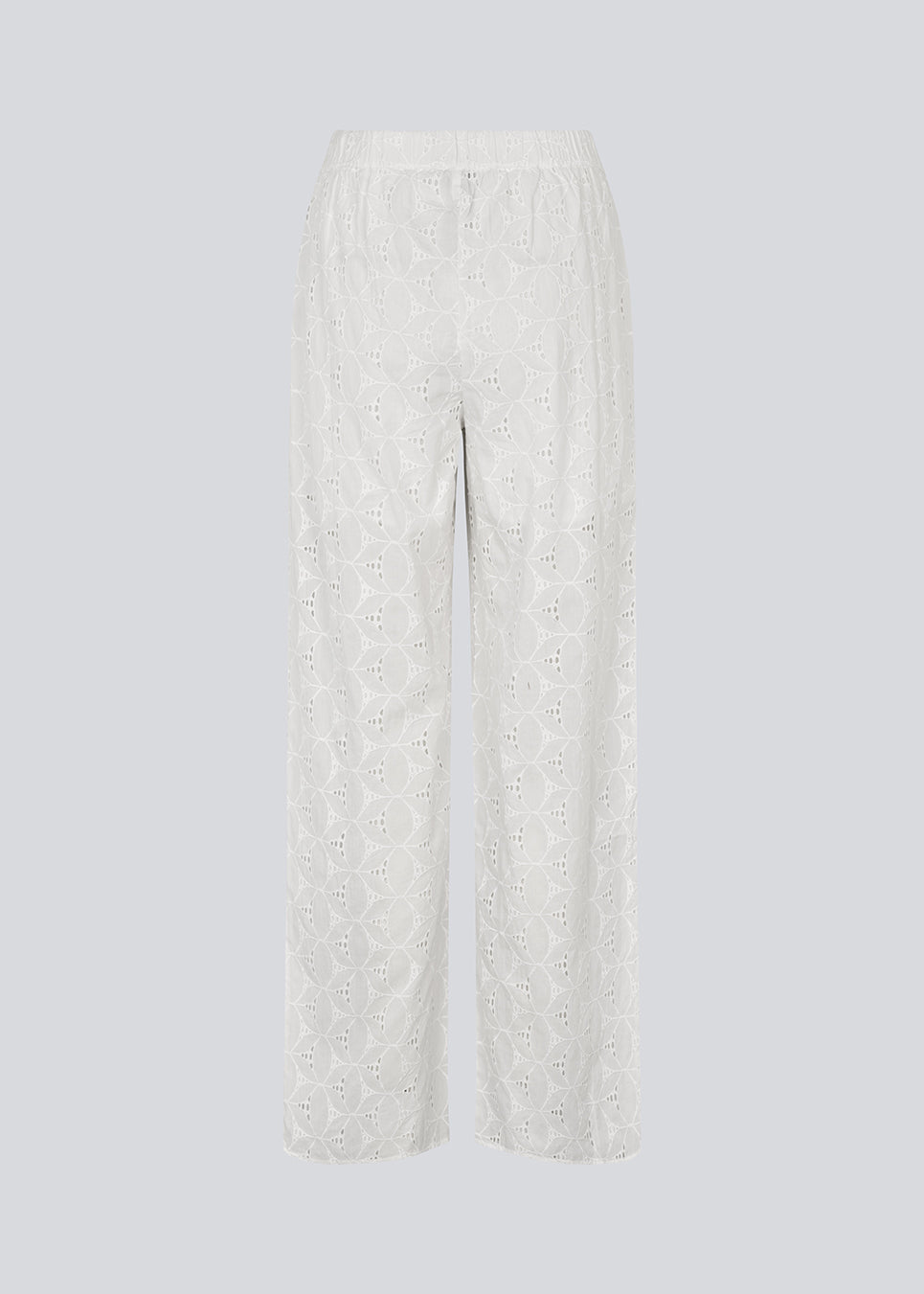 White pants with wide legs in broderie anglaise. NanetteMD pants have an elastic waistband and lining.