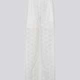 White pants with wide legs in broderie anglaise. NanetteMD pants have an elastic waistband and lining.