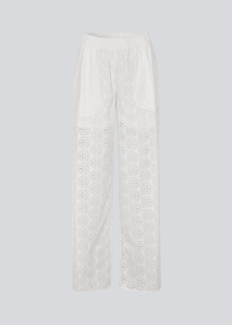 White pants with wide legs in broderie anglaise. NanetteMD pants have an elastic waistband and lining.