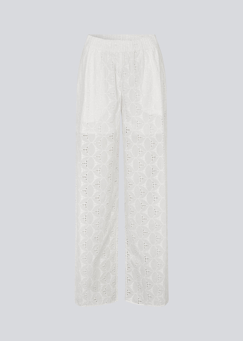 White pants with wide legs in broderie anglaise. NanetteMD pants have an elastic waistband and lining.