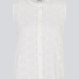 Sleeveless white top in broderie anglaise. NanetteMD top has a high neck and a button closure in front.
