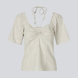 Short-sleeved top with tiedetails in 100% organic cotton. NanikaMD top has a tieband which wraps around the neck, an elastic silicone tape at the
