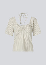 Short-sleeved top with tiedetails in 100% organic cotton. NanikaMD top has a tieband which wraps around the neck, an elastic silicone tape at the
