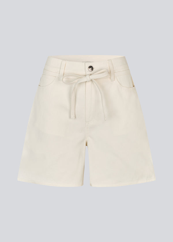 White denim shorts with wide legs in cotton denim. Naomamd solid shorts have a high waist, front and back pockets, and a tie band at the waist.