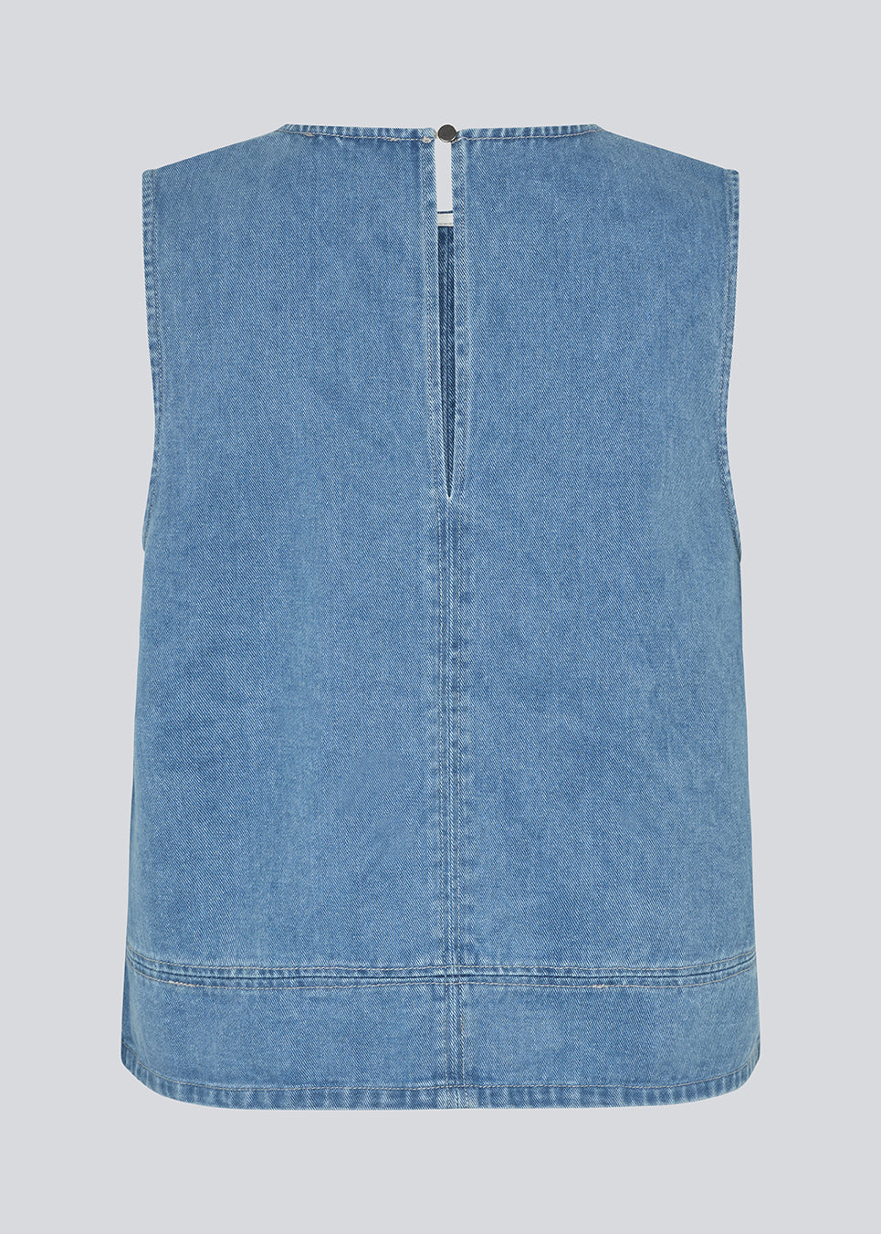 Sleeveless blue top with a round neck in cotton denim. NaomaMD solid top has a loose fit and an opening in the neck with a button closure.