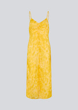 Maxi dress in yellow with thin straps and an elastic gathering at the chest. Napthalimd print strap dress has a slit in the front and an invisible zipper at the back.