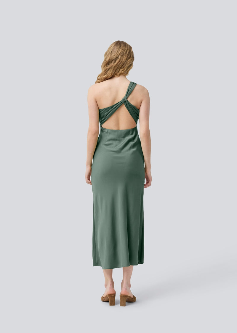 Long one shoulder dress in green in satin. NarcissaMD dress has an open back with beautiful details and an invisible zipper in the side.
