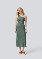 Long one shoulder dress in green in satin. NarcissaMD dress has an open back with beautiful details and an invisible zipper in the side.