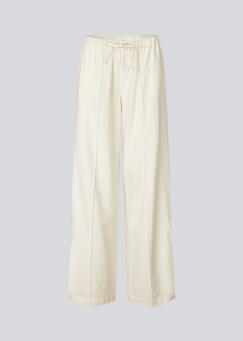 Loose white pants with wide legs made in 100% cotton. NasirMD pants have side pockets, an elastic waist with a string, and a stitched press fold at the front.