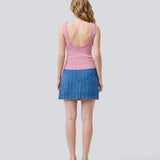 Sleeveless pink top in a shimmery knit. NavalMD top has a round neckline and a deep back.