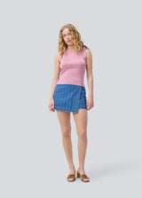 Sleeveless pink top in a shimmery knit. NavalMD top has a round neckline and a deep back.