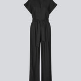 Black jumpsuit with wide legs and a tieband at the waist. NedraMD jumpsuit has a collar, v-neck, and a zipper at front.